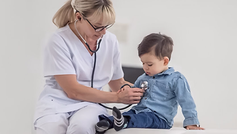 Nurse taking the heartbeat of a child